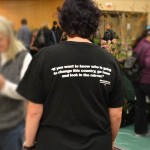 Barbara shows me the back of her shirt at Seedy Saturday in Victoria